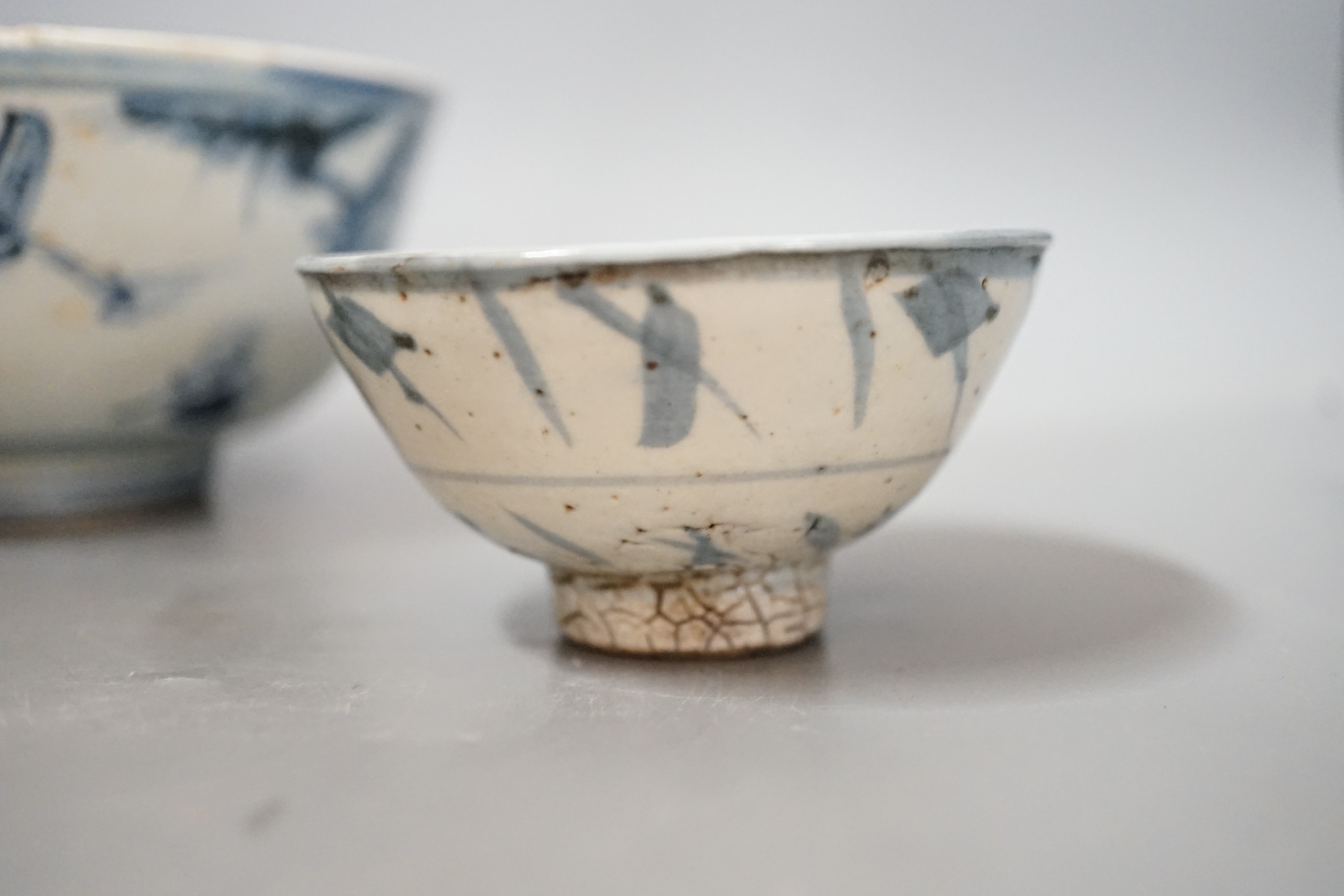 Three Chinese late Ming blue and white bowls, one painted with figures in a boat on horseback and in the landscape, the second with floral sprays, with ‘Made in the Great Ming dynasty’ mark and another bowl, largest 13.3